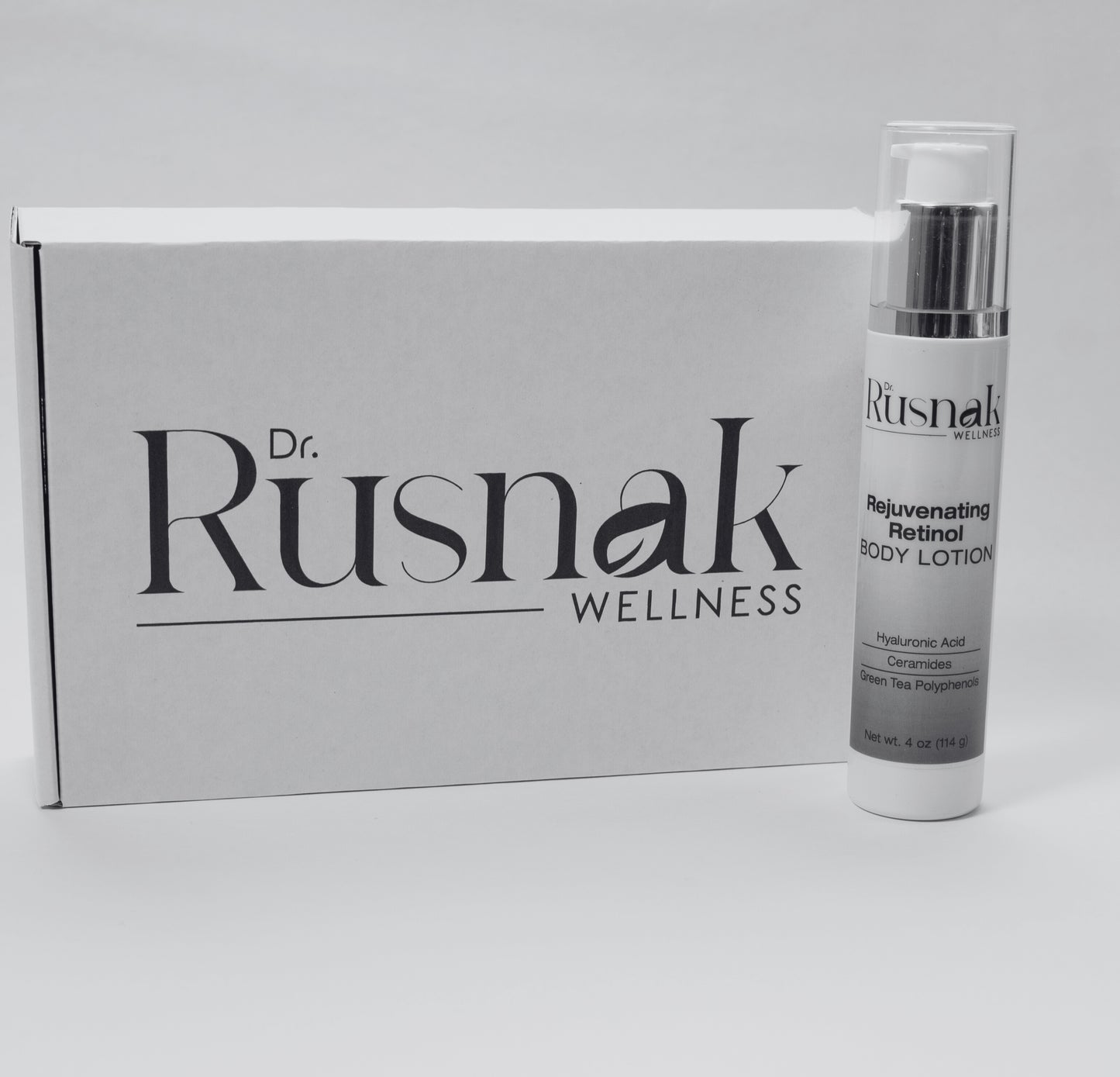 Dr Rusnak Wellness Anti-Aging Body Moisturizer with Retinol bottle with packaging on a gray background